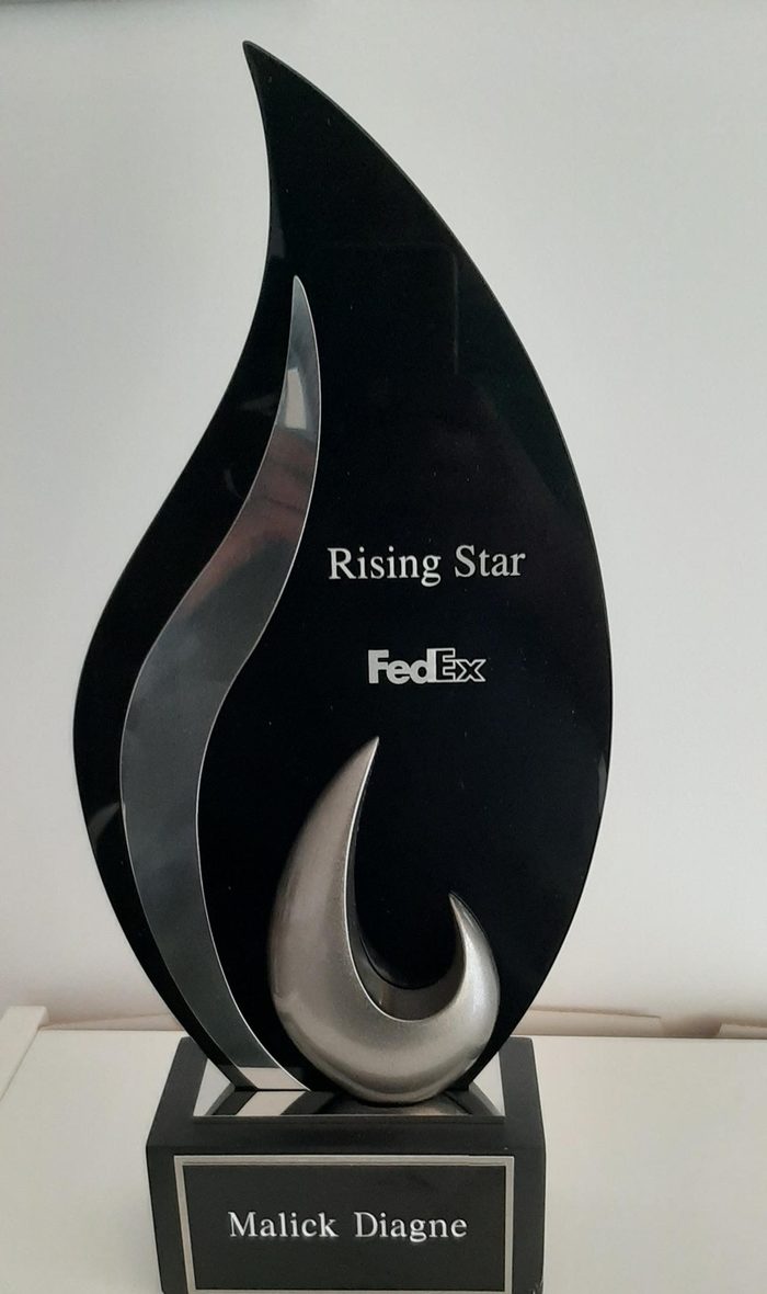 FedEx Rising Star trophy engraved with the name Malick Diagne